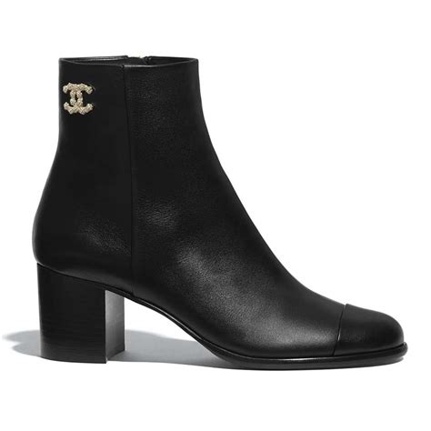 saks chanel boots|Chanel black canvas heel boots.